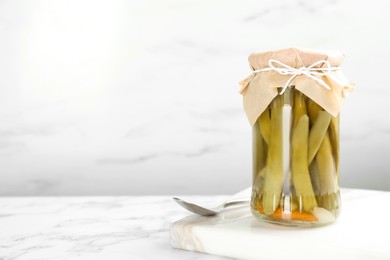 Photo of Canned green beans on white marble table. Space for text