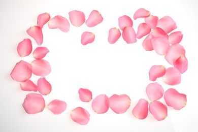 Photo of Frame made of pink rose petals on white background, top view