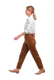 Beautiful happy businesswoman walking on white background