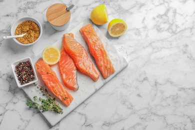 Fresh salmon and ingredients for marinade on table, top view