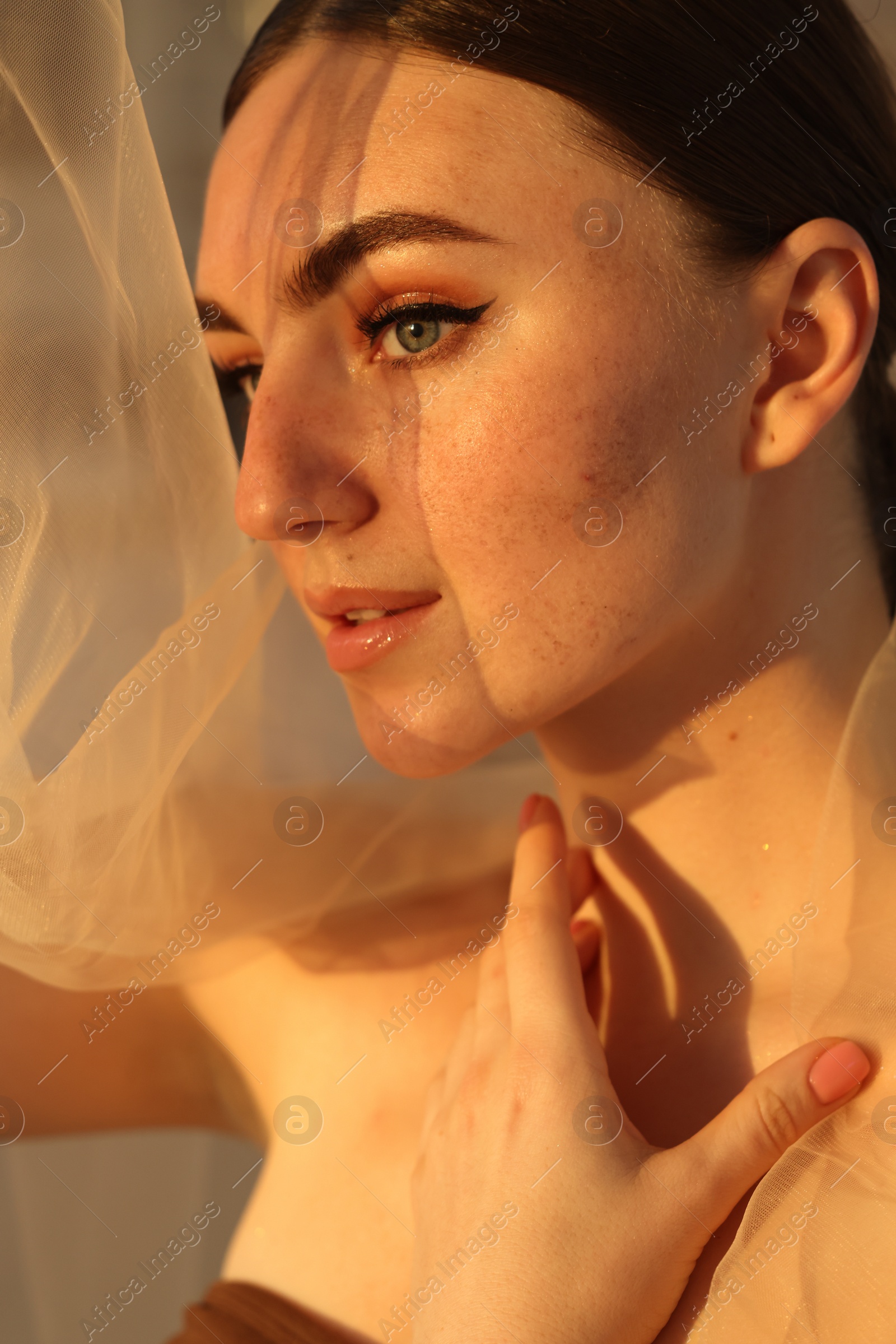 Photo of Fashionable portrait of beautiful woman with fake freckles, closeup