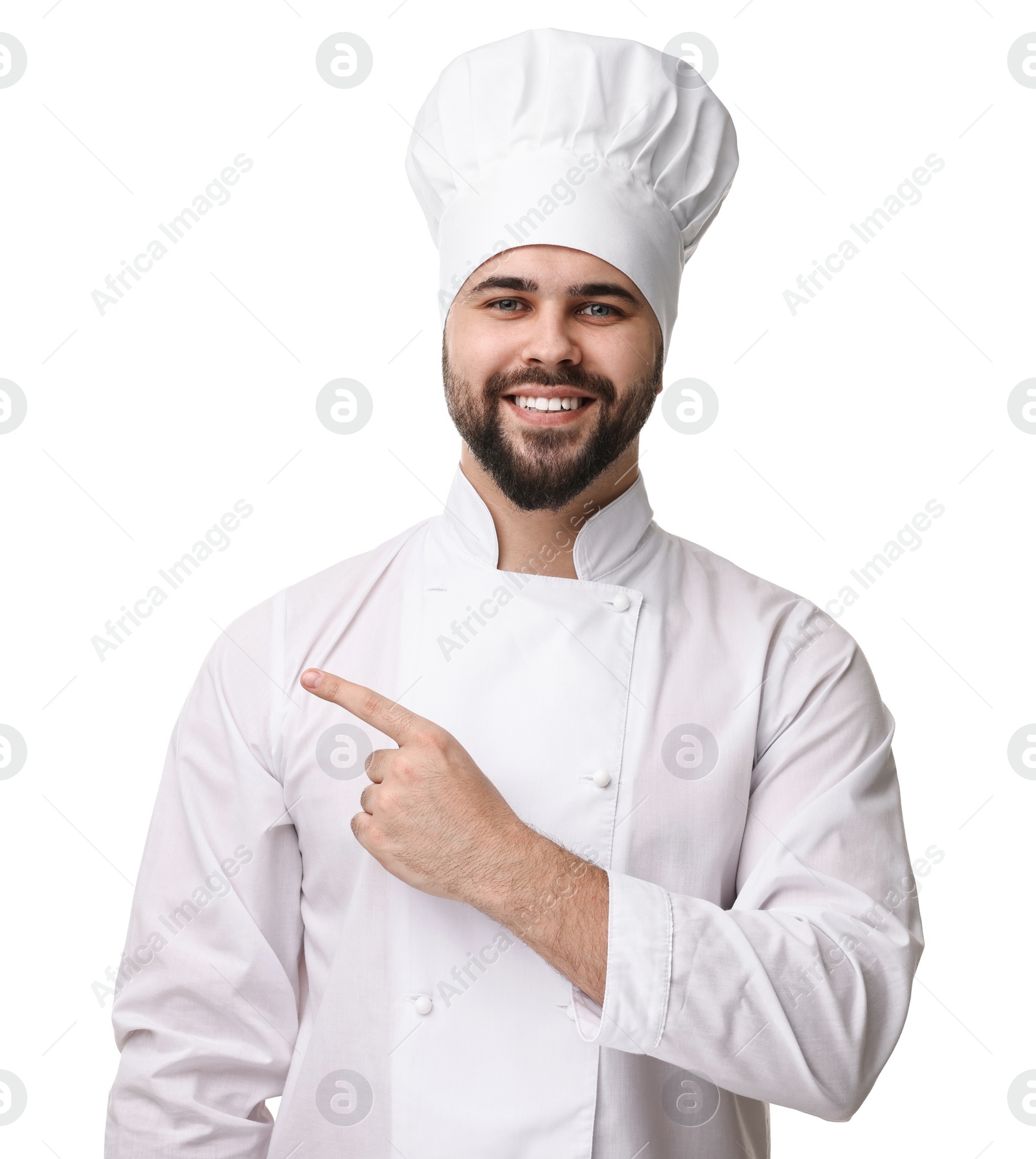 Photo of Happy young chef in uniform pointing at something on white background