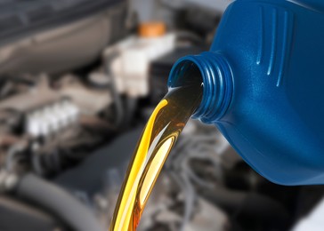 Image of Pouring motor oil from blue container, closeup