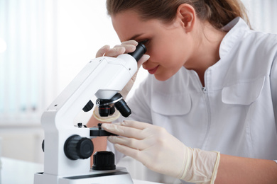 Photo of Scientist using modern microscope at table, closeup. Medical research