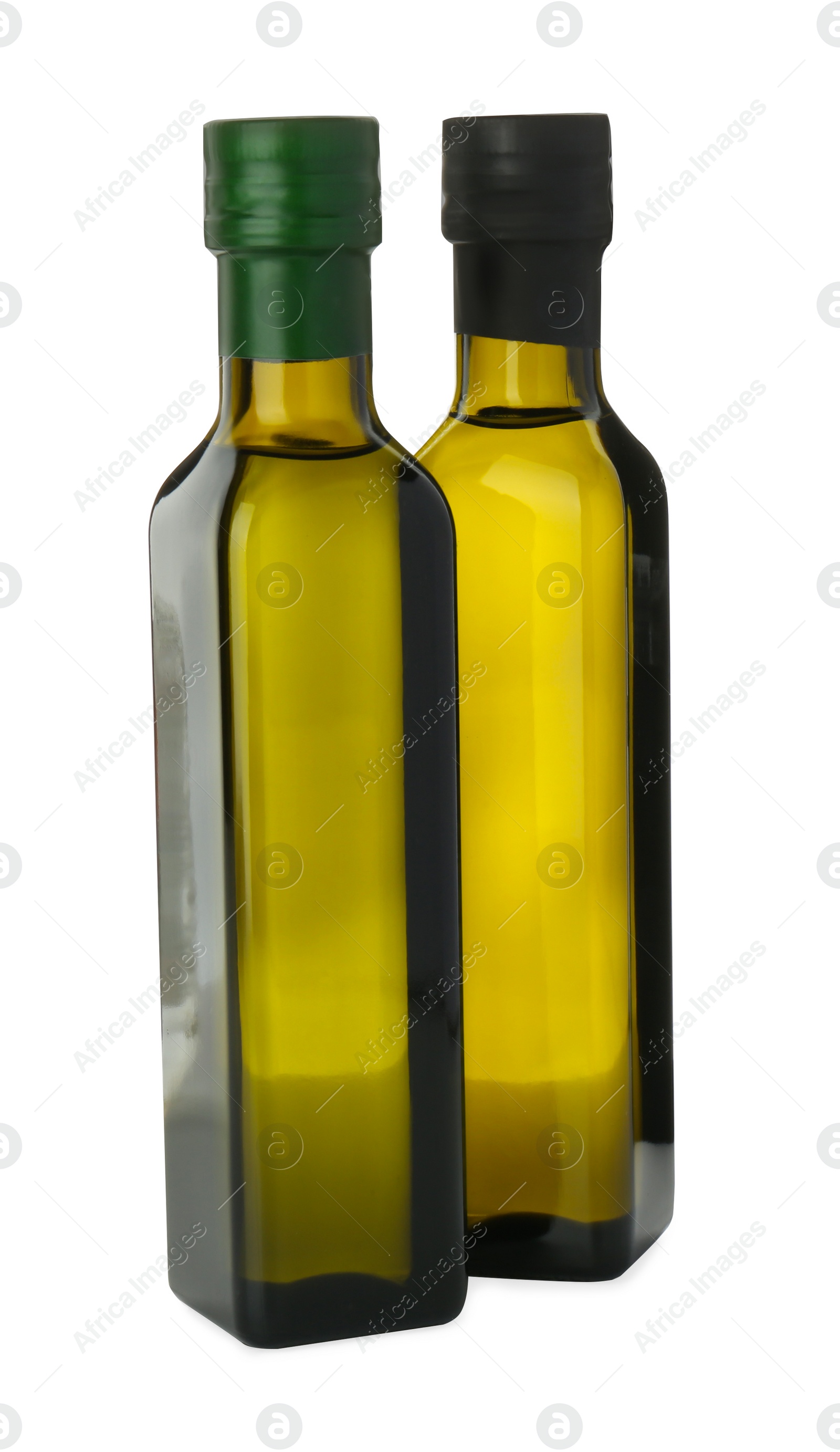 Photo of Vegetable fats. Cooking oils in glass bottles isolated on white