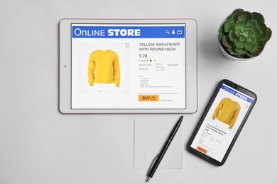 Photo of Online shopping. Flat lay composition with modern tablet and smartphone on white background