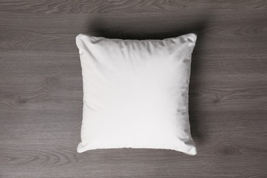 Photo of Blank soft pillow on wooden background, top view