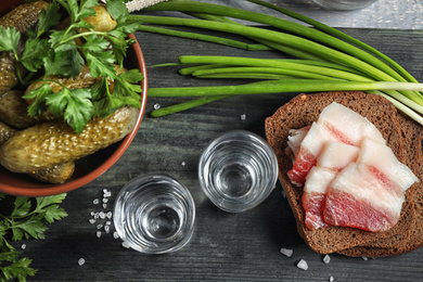 Photo of Flat lay composition with cold Russian vodka on black wooden table