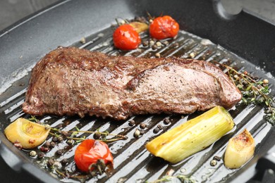 Photo of Delicious grilled beef meat and vegetables in pan, closeup