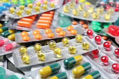 Photo of Heap of different pills in blister packs, closeup