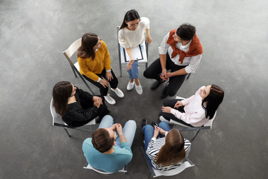 Photo of Psychotherapist working with patients in group therapy session, top view