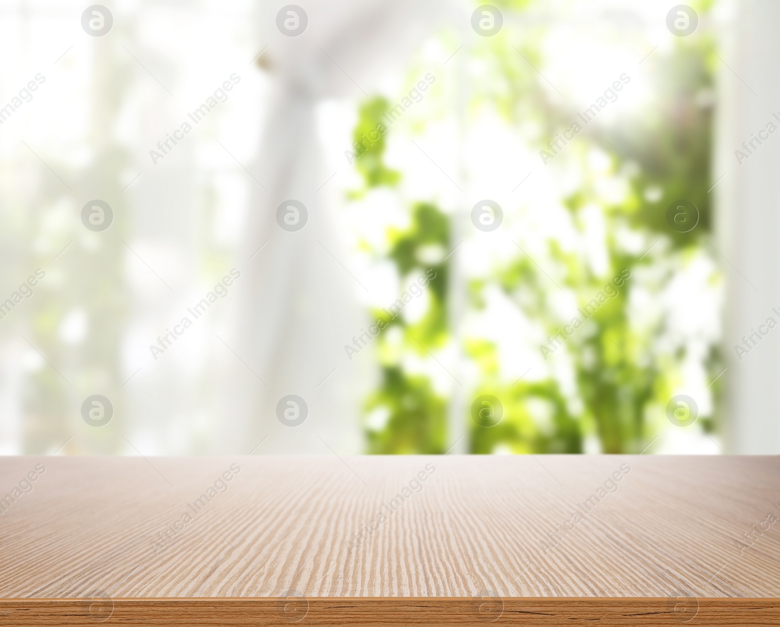 Image of Empty wooden table in front of window. Sunny morning 