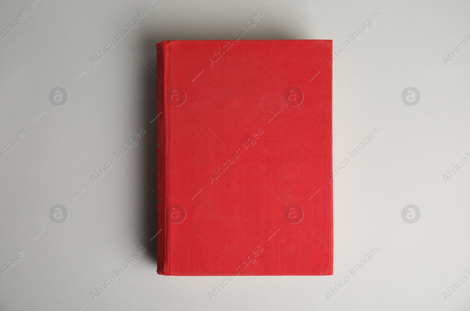Photo of Hardcover book on light grey background, top view. Space for design