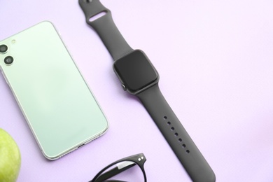 Photo of Flat lay composition with stylish smart watch on violet background
