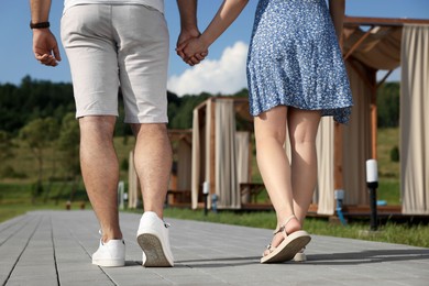 Romantic date. Couple walking outdoors, closeup view