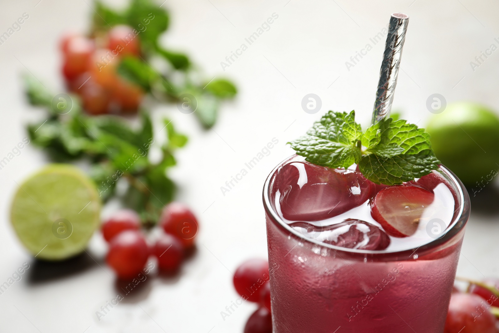 Photo of Refreshing drink with soda water, grapes and ice, closeup. Space for text