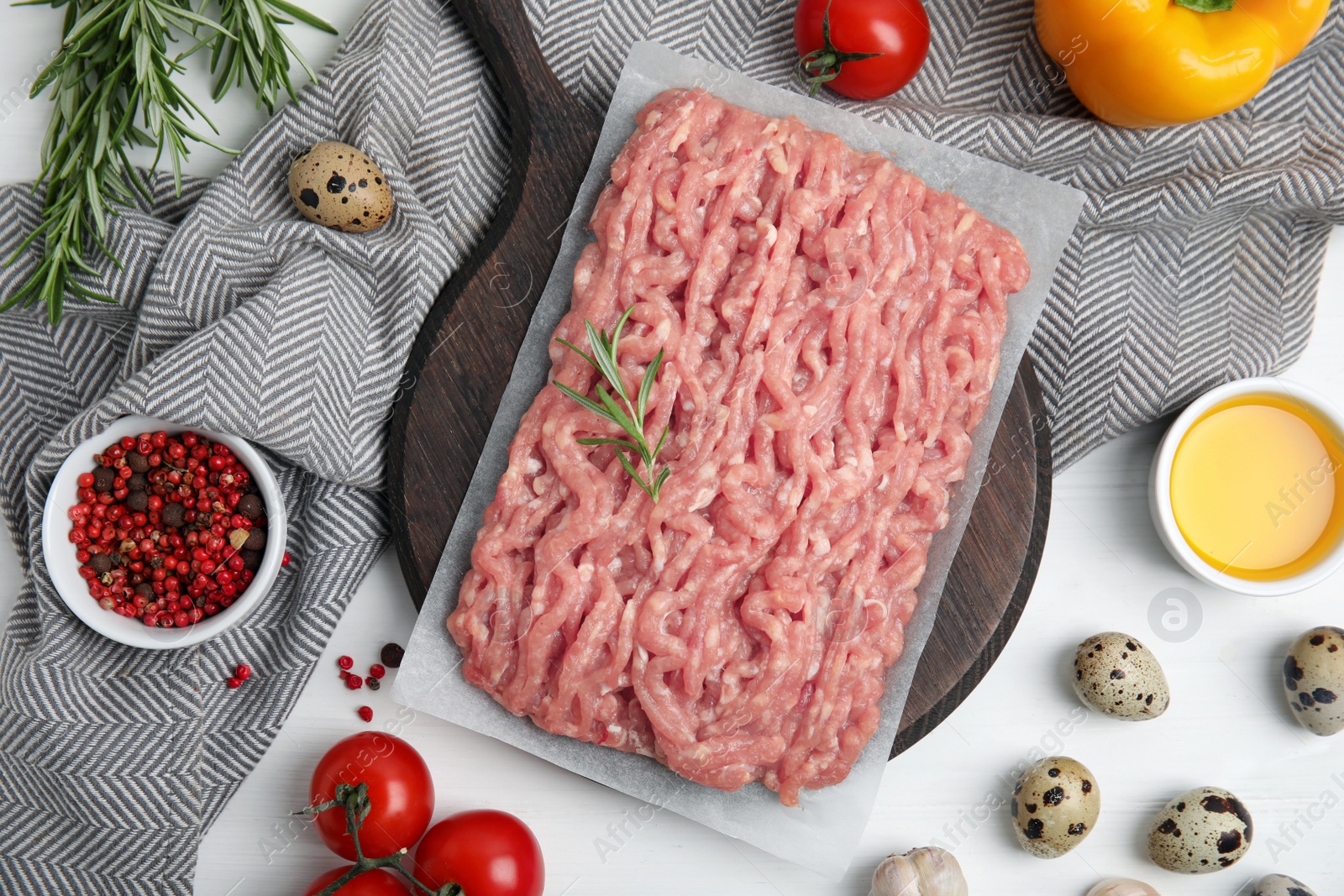 Photo of Raw chicken minced meat and ingredients on white wooden table, flat lay