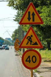 Photo of Traffic signs on city street. Road repair