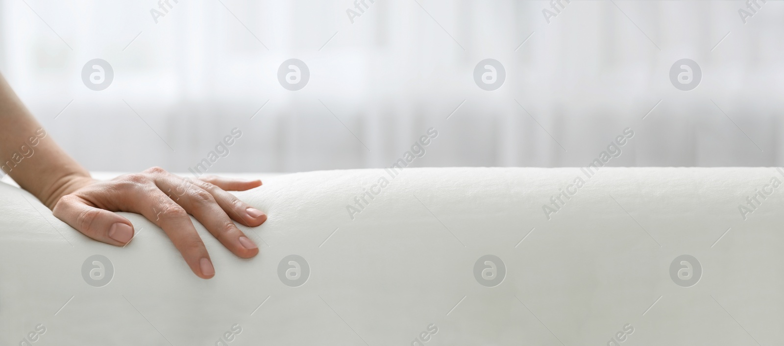 Image of Woman touching memory foam pillow indoors, closeup. Banner design with space for text