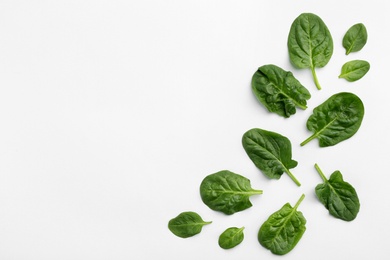 Photo of Fresh leaves of spinach isolated on white, top view