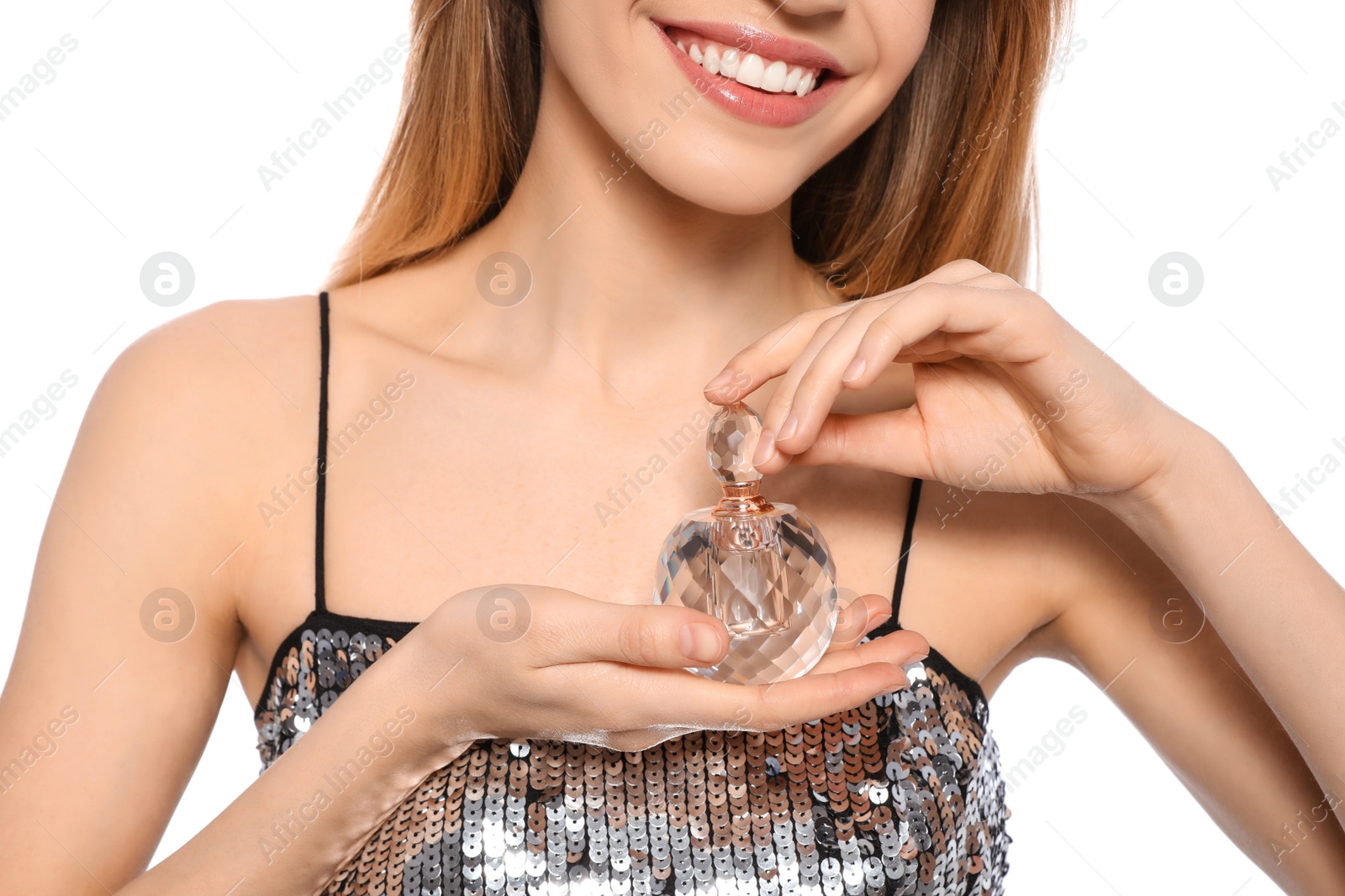 Photo of Young woman with bottle of perfume on white background, closeup