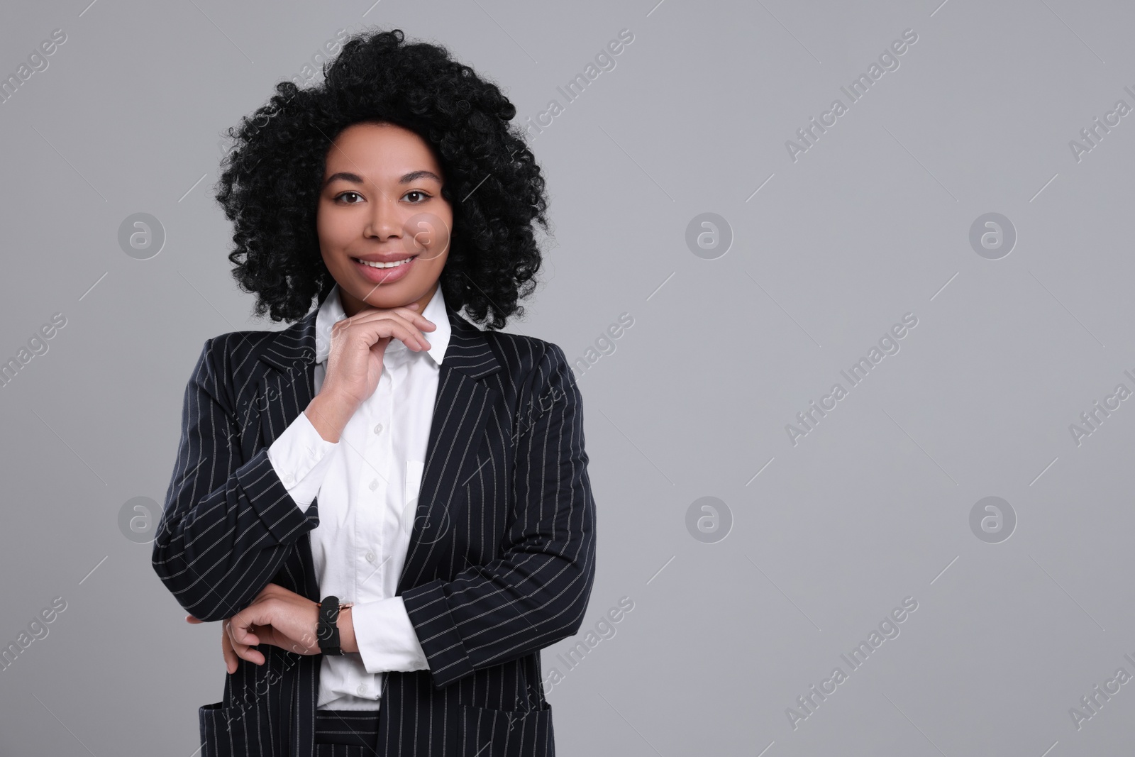 Photo of Young businesswoman in formal outfit on grey background. Space for text