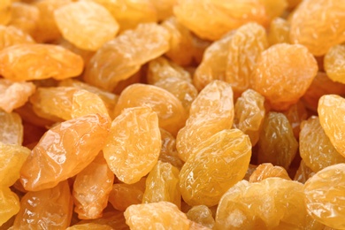 Photo of Tasty raisins as background, closeup. Healthy dried fruit