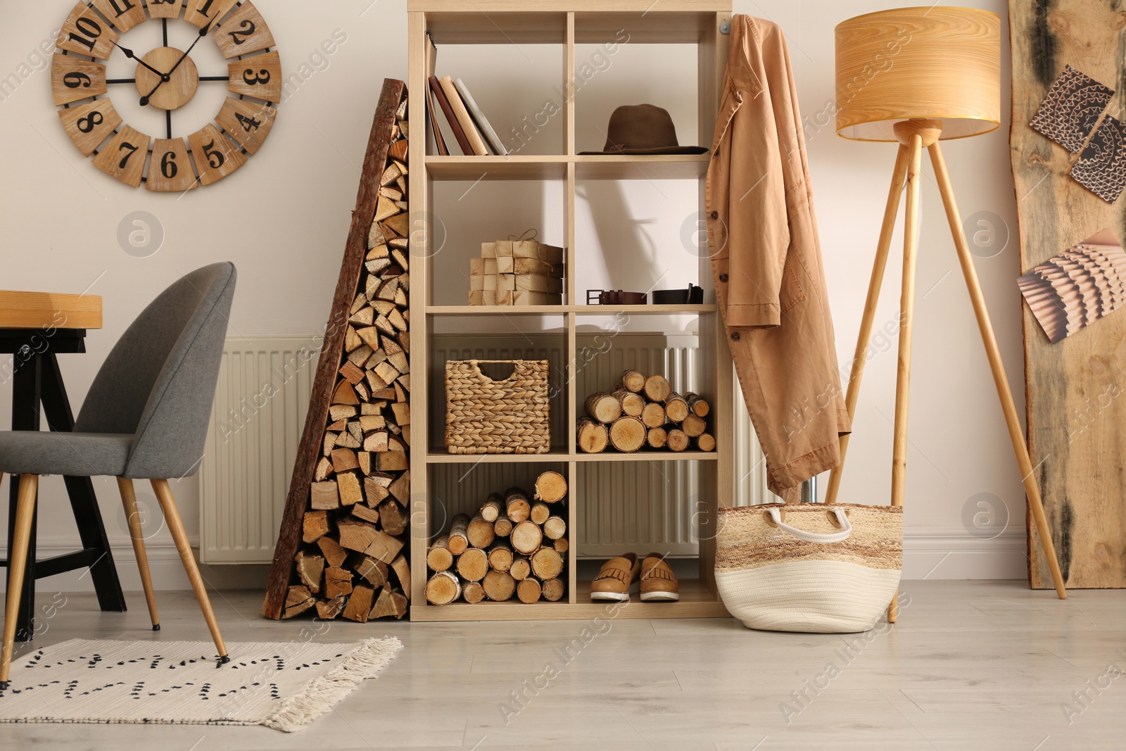 Photo of Stylish room interior with firewood as decorative element