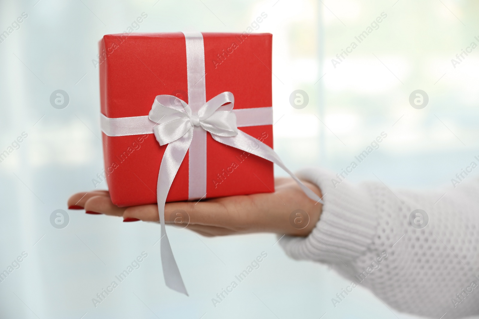 Photo of Woman holding gift box on white background, closeup. Christmas holiday