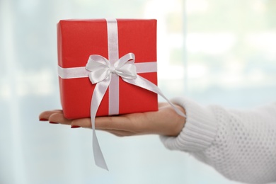 Photo of Woman holding gift box on white background, closeup. Christmas holiday