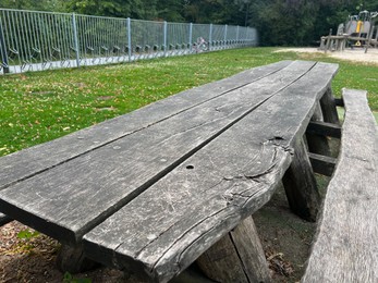 Photo of Empty wooden picnic table with bench outdoors