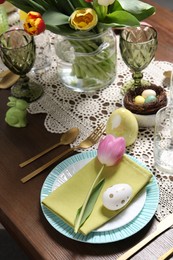 Festive table setting with beautiful flowers. Easter celebration