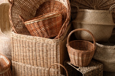 Photo of Many different wicker baskets made of natural material as background, closeup