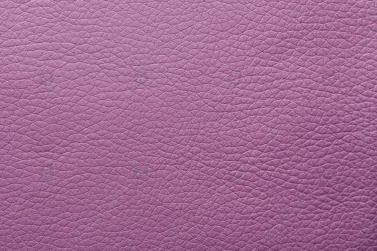 Photo of Texture of violet leather as background, closeup