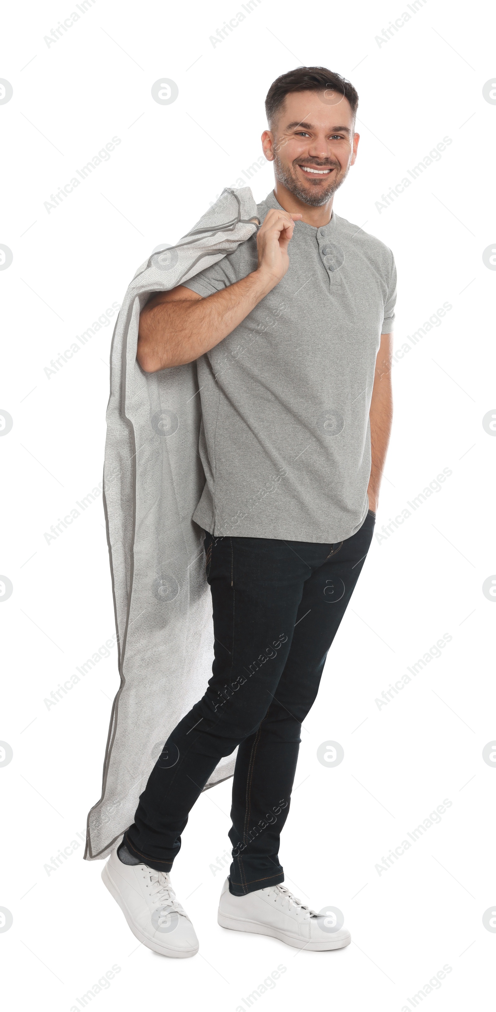 Photo of Man holding garment cover with clothes on white background. Dry-cleaning service