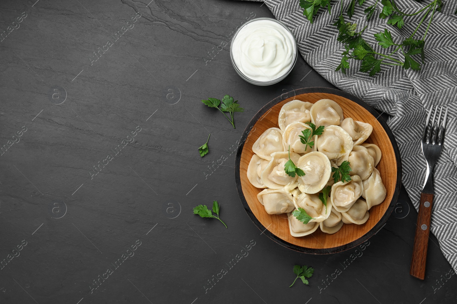 Photo of Flat lay composition with tasty dumplings on black table, flat lay. Space for text