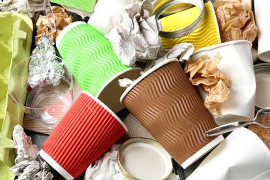 Photo of Pile of different garbage as background, top view. Recycling problem