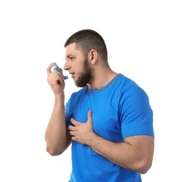 Photo of Young man using asthma inhaler on white background