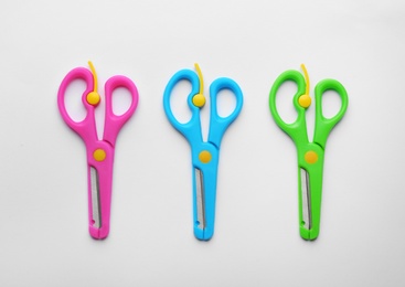 Photo of Set of training scissors on white background, top view