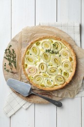 Photo of Tasty leek pie with thyme on white wooden table, top view