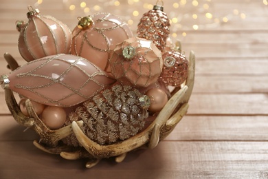 Photo of Collection of beautiful Christmas tree baubles on wooden table, closeup