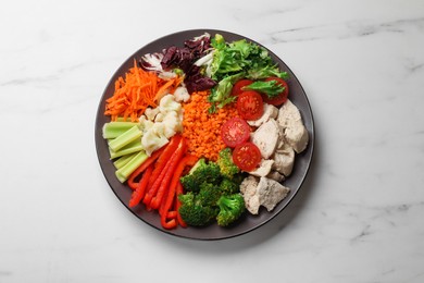 Photo of Balanced diet and healthy foods. Plate with different delicious products on white marble table, top view