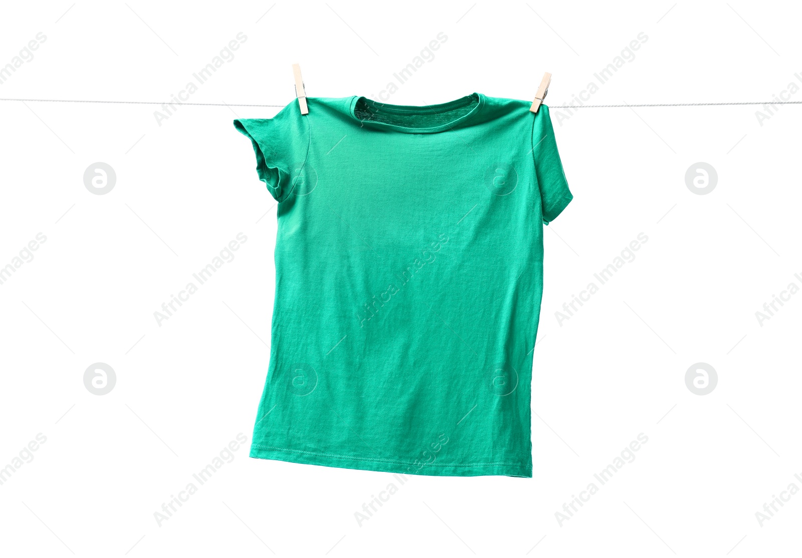 Photo of One green t-shirt drying on washing line isolated on white