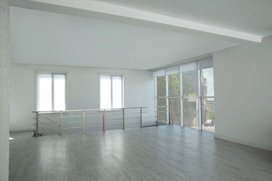 Photo of Large empty hall with windows and railings