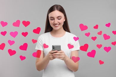 Long distance love. Woman chatting with sweetheart via smartphone on grey background. Hearts flying out of device and swirling around her