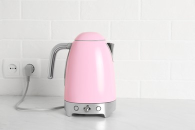 Photo of Modern electric kettle on counter in kitchen