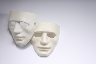 Theater arts. Two masks on white background, above view. Space for text