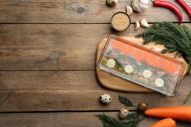 Delicious aspic with meat and ingredients on wooden table, flat lay. Space for text