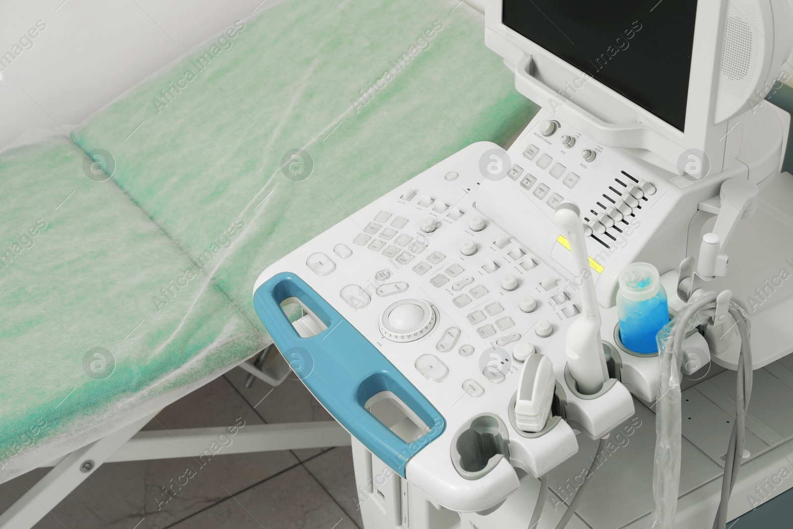 Photo of Ultrasound control panel and examination table in hospital, closeup