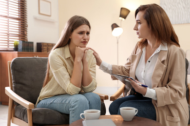 Photo of Professional psychotherapist working with patient in office